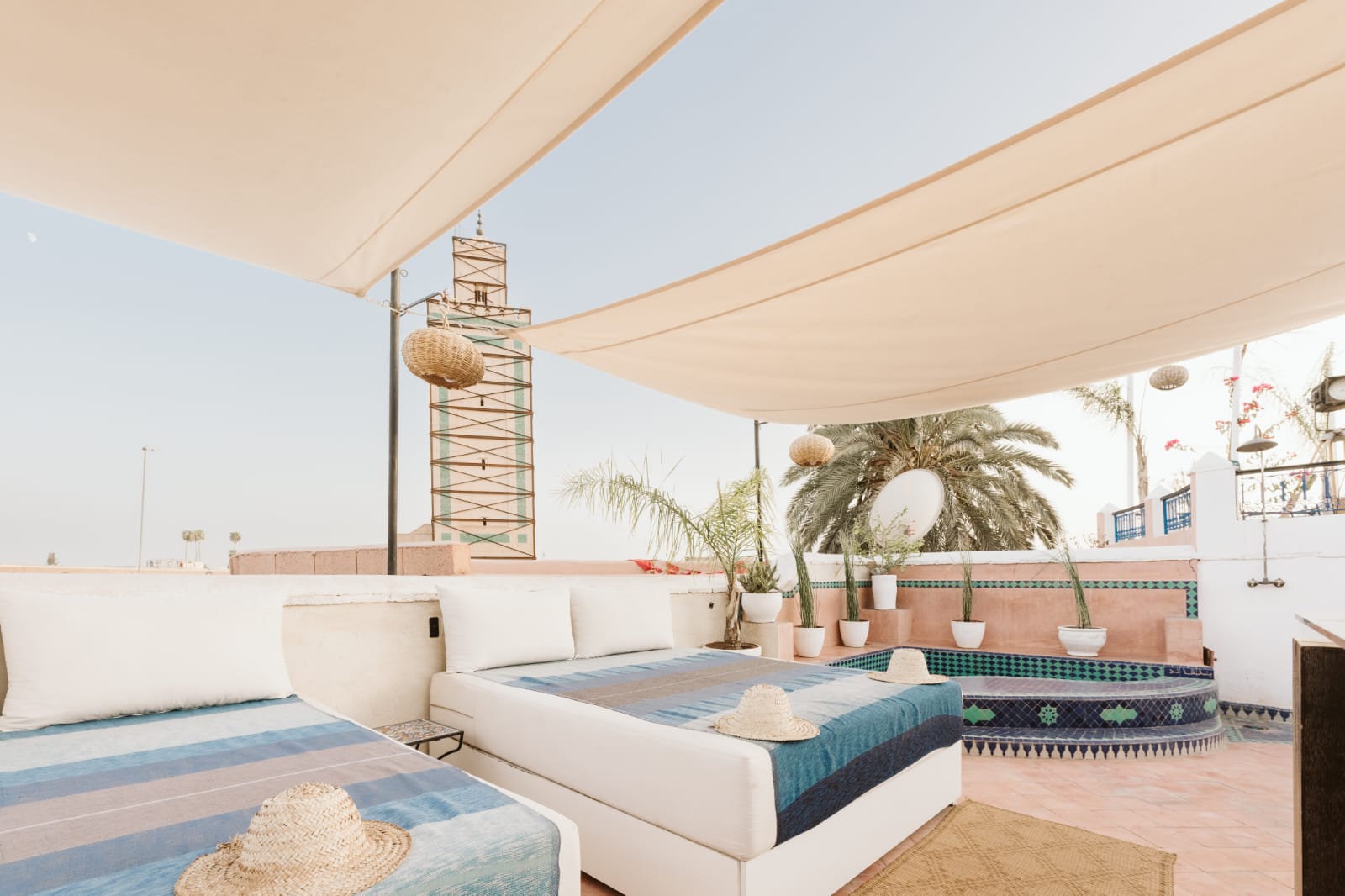 Rooftop terrace with sun sails, daybed and plunge pool at Riad Dar Alhambra Marrakech